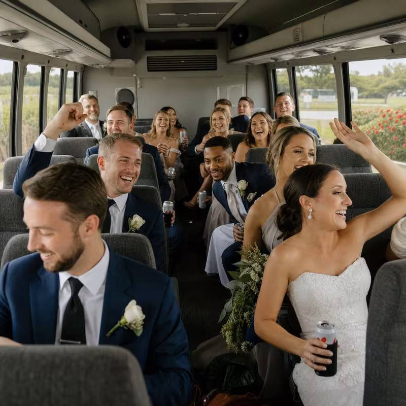 Group boarding a white charter bus for Wedding Transportation transportation in Jacksonville