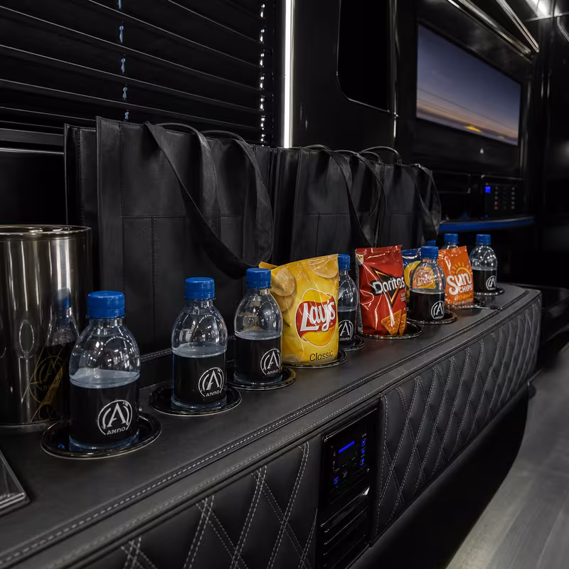 Party bus interior with wraparound leather seating and LED lighting in Jacksonville
